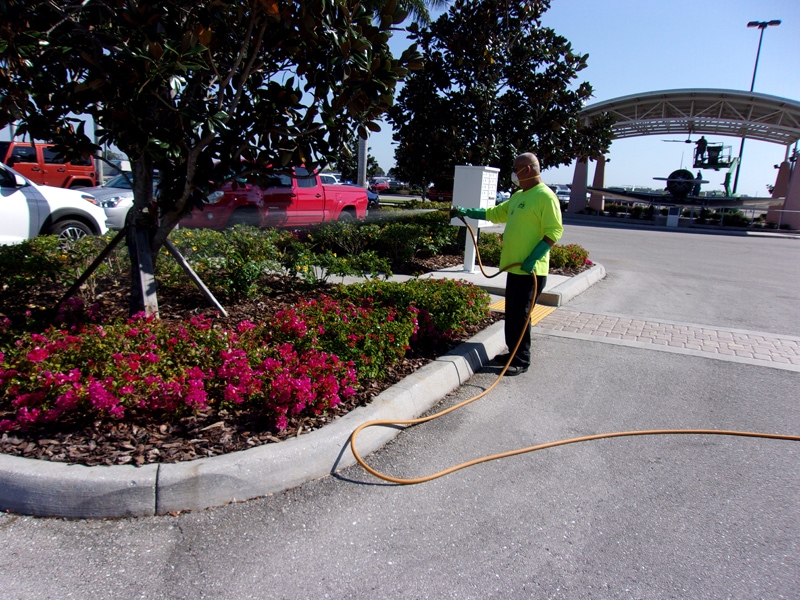 P & T Landscaping watering plants in the parking lot at the Lee County Port Authority
