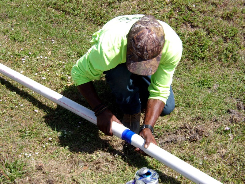 Irrigation and Lighting Team Putting Glued Pipes Together on the Ground